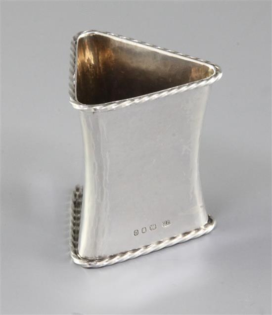 A 1930s Arts & Crafts silver waisted triangular napkin ring, by Omar Ramsden, Height 58mm weight 1.8oz/57grms
